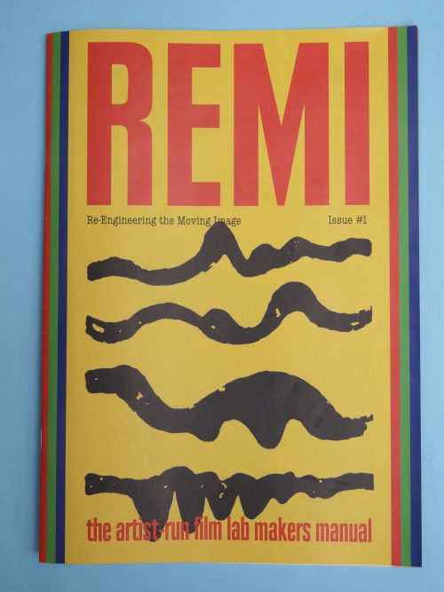 A colour photograph of a front cover of a book. The words REMI run along the top in red, over the dull yellow of the cover, and painted black lines of various thicknesses run across the cover's centre. Along the book, are the words, in red: the artist run film lab makers manual