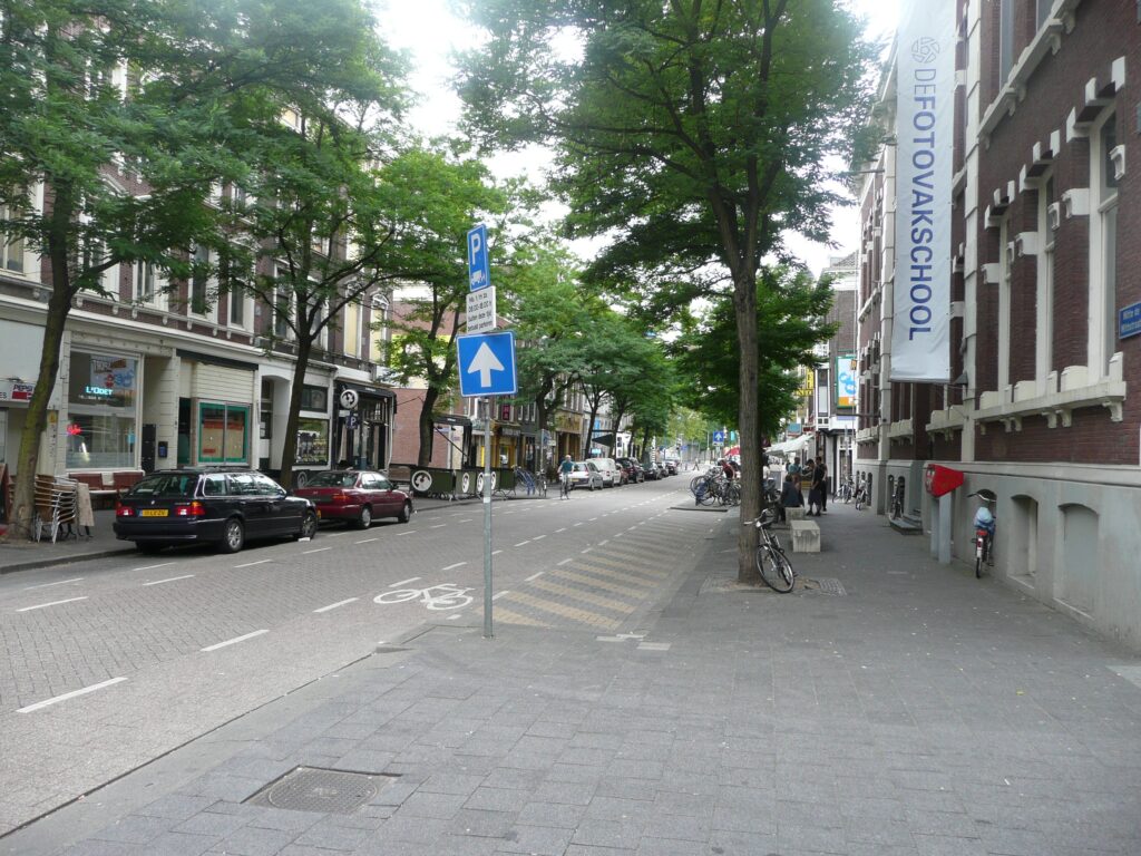 Colour photograph of the Witte de Withstraat in the 2000s, showing the Fotovakschool banner flying where WORM's #Wunderbar is now to be found.