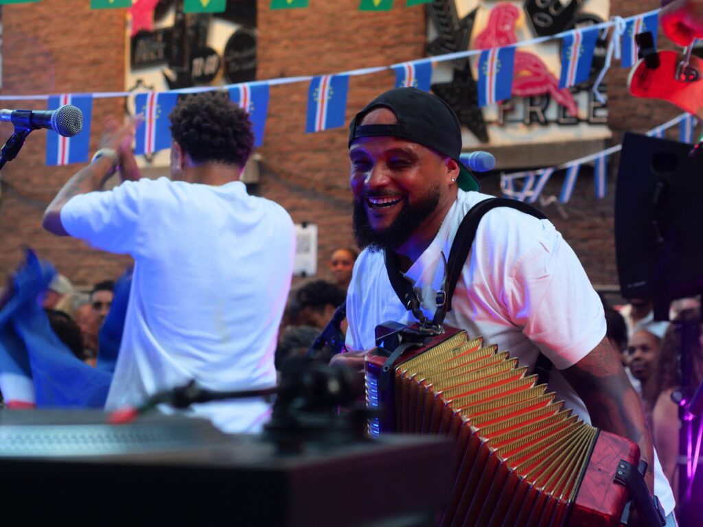 Colour photo by WORM club programmer Frederik Teixeira showing a street scene of partying and creative people during the block party for the Farroffa x WORM event July 2026