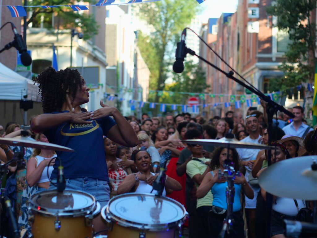 Colour photo by WORM club programmer Frederik Teixeira showing a street scene of partying and creative people during the block party for the Farroffa x WORM event July 2026