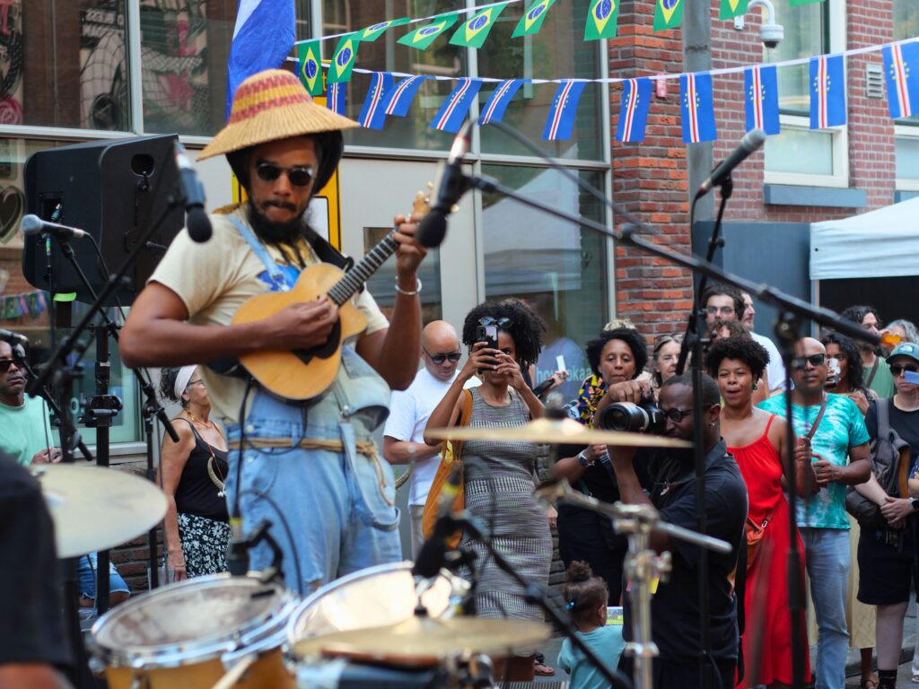 Colour photo by WORM club programmer Frederik Teixeira showing a street scene of partying and creative people during the block party for the Farroffa x WORM event July 2026