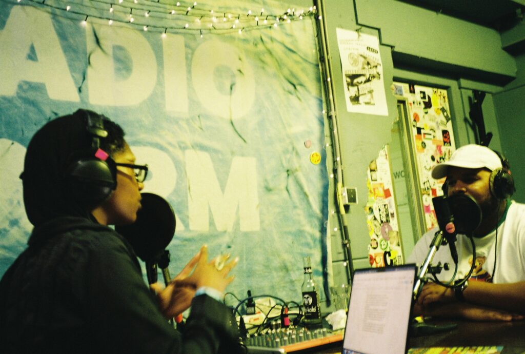 Colour photo by WORM club programmer Frederik Teixeira showing a radio interview at Radio WORM during the first edition of Roots and Riddims July 2025