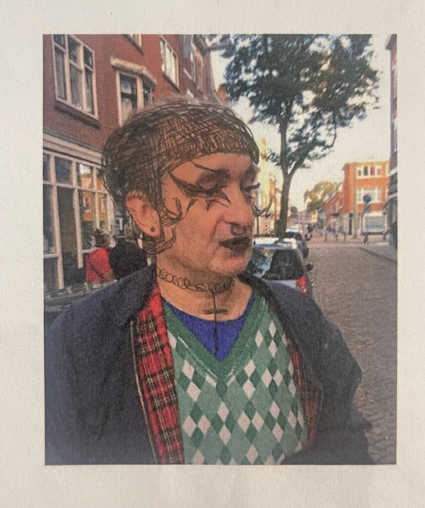 Colour photo of a colour scan of Lukas Simonis wearing a MES jumper. The photo has been scribbled on